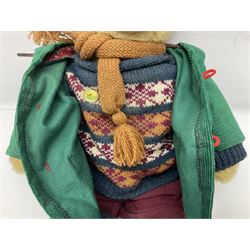 Lakeland Bears teddy bear, titled 'Walkright', dressed as a hiker in green corduroy duffle coat over fair isle jumper, trousers and knit socks, complete with leather clogs with wood soles, walkers thumb stick, knitted scarf, flat cap and rucksack housing original tag and map, H50cm