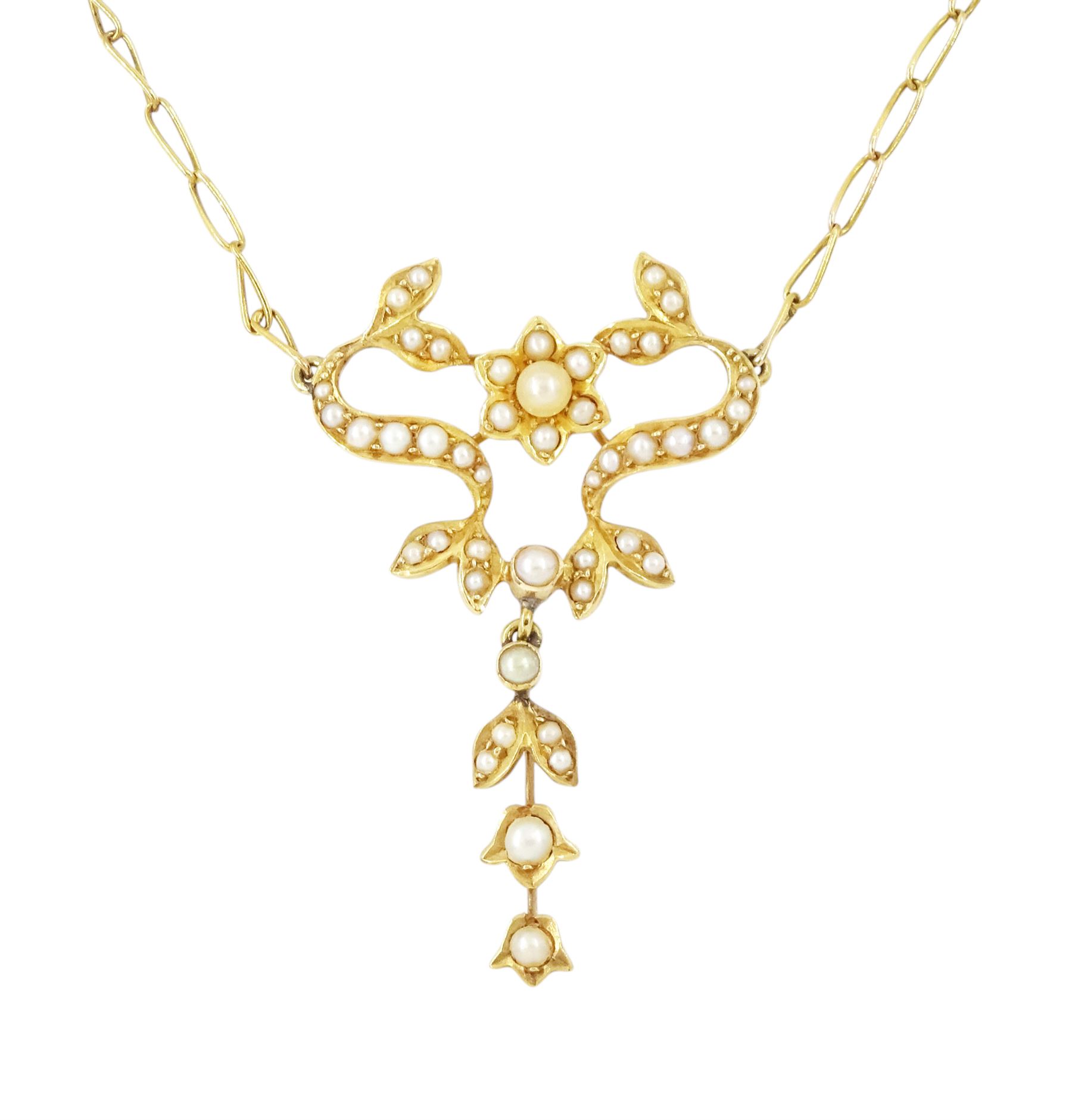 Edwardian gold split pearl pendant necklace, openwork floral pendant set with split pearls on a fancy link chain necklace