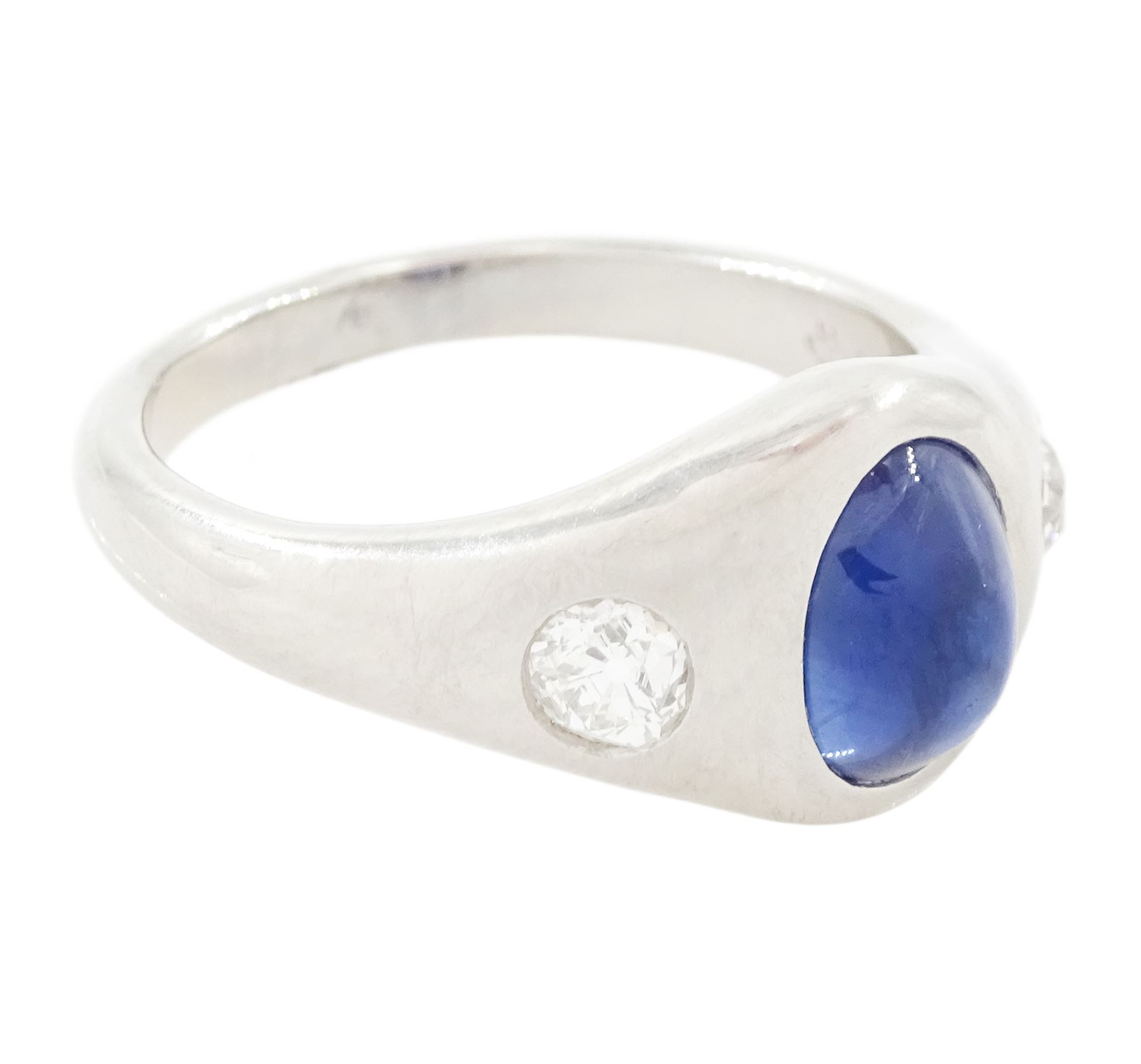 Platinum sapphire and diamond three stone ring, single cabochon sapphire of 1.65 carat, with a rubover set old cut diamond set either side, stamped 850 Plat, total diamond weight 0.42 carat