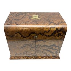 19th century walnut decanter box by Charles Henry of Manchester, painted to enhance the grain, of rectangular form with twin recessed brass carry handles to sides, twin deep section doors to front, and curved hinged cover with inset brass cartouche above a banner inscribed 'Durham House', opening to reveal an inset brass plaque inscribed 'Charles Henry Manchester', and Royal blue velvet lined and compartmented interior containing circular gilt tray, two square section decanters flanking a central glass claret jug, and a number of drinking glasses held in gilt supports, H29cm W38cm D24.5cm