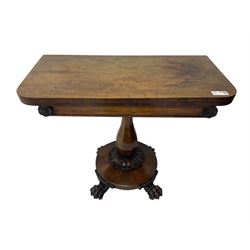 Victorian mahogany tea table, rectangular top with rounded corners, folding and swivelling to reveal interior surface, supported on a faceted baluster-shaped column, raised on a circular platform base with carved acanthus details, ending in four lion paw feet