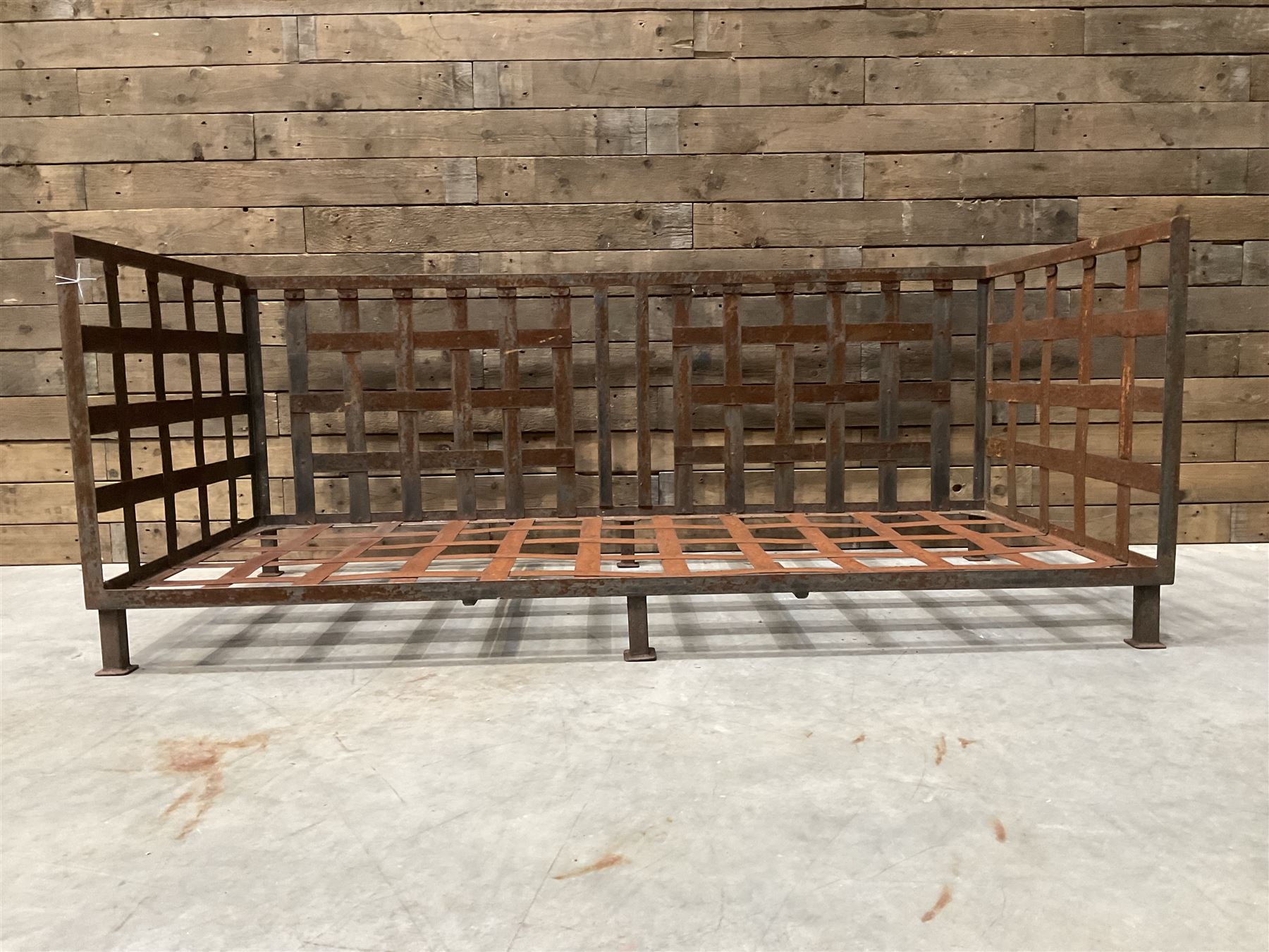 Wrought iron strapwork garden day bed, lattice back and sides