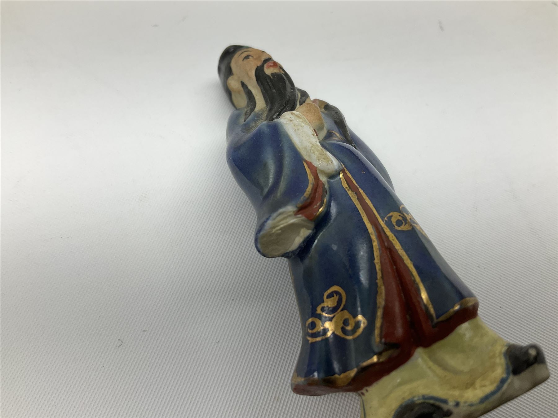 Japanese parquetry puzzle box L12cm; another Japanese puzzle box with marquetry top of Mount Fuji; eleven graduated Chinese figures including immortals; and Chinese figure of a lady standing on a hardwood base next to a horn table (14)