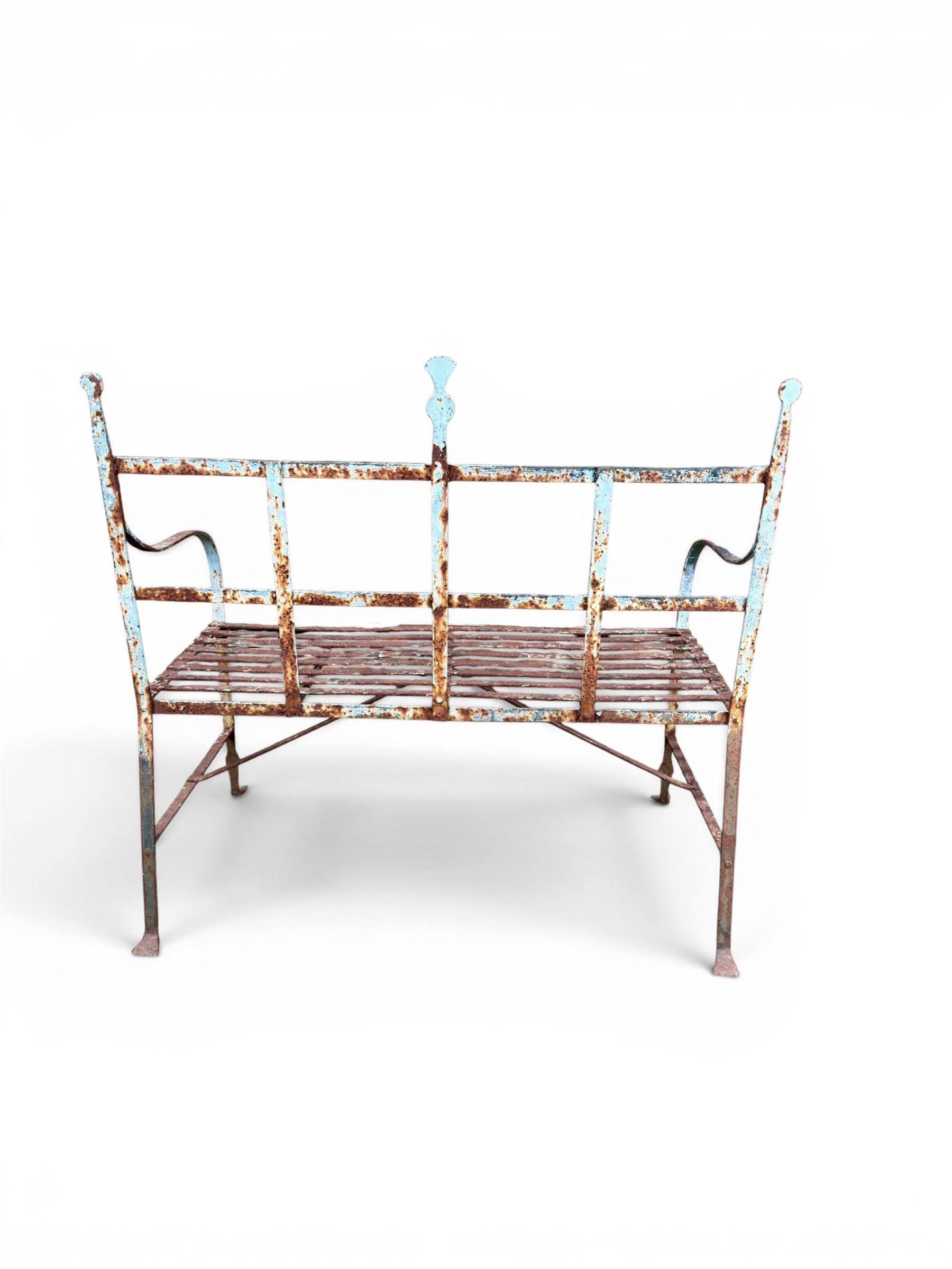 Regency period wrought iron strapwork garden bench, cresting rail with central Scottish thistle motif and flanking pediments, in distressed blue painted finish