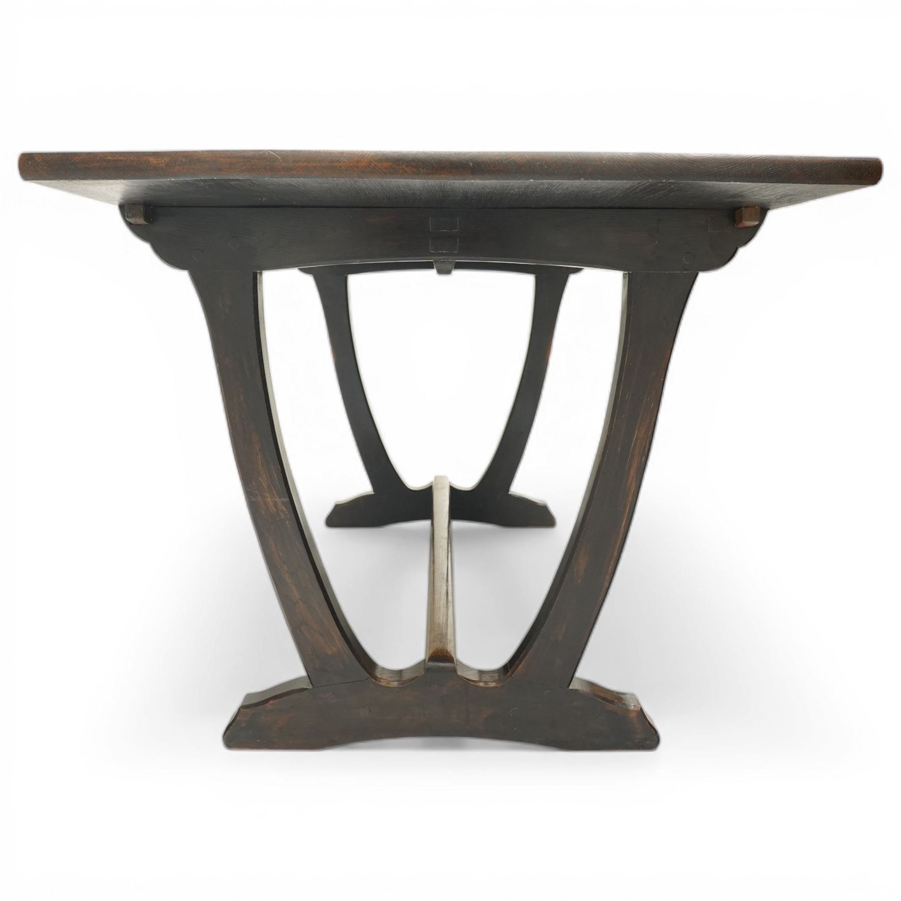 Acornman - dark stained oak dining table, rectangular top raised wishbone end supports united by stretcher, with carved acorn signature, by the workshop of Alan Grainger of Brandsby