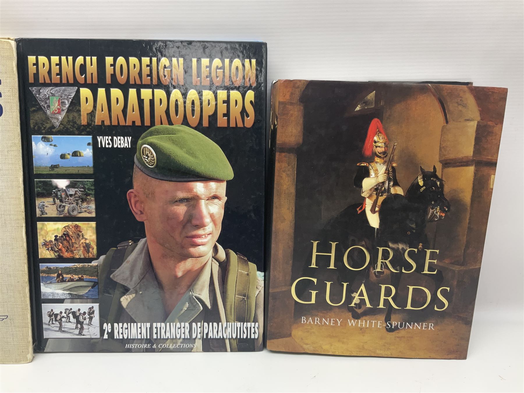 Seven military reference books - Histoire Mondiale Des Parachutistes; Yves Debay: French Foreign Legion  Paratroopers; Bragg & Turner: Parachute Wings; Barney White-Turner: Horse Guards; and three works on uniforms/standards (7)