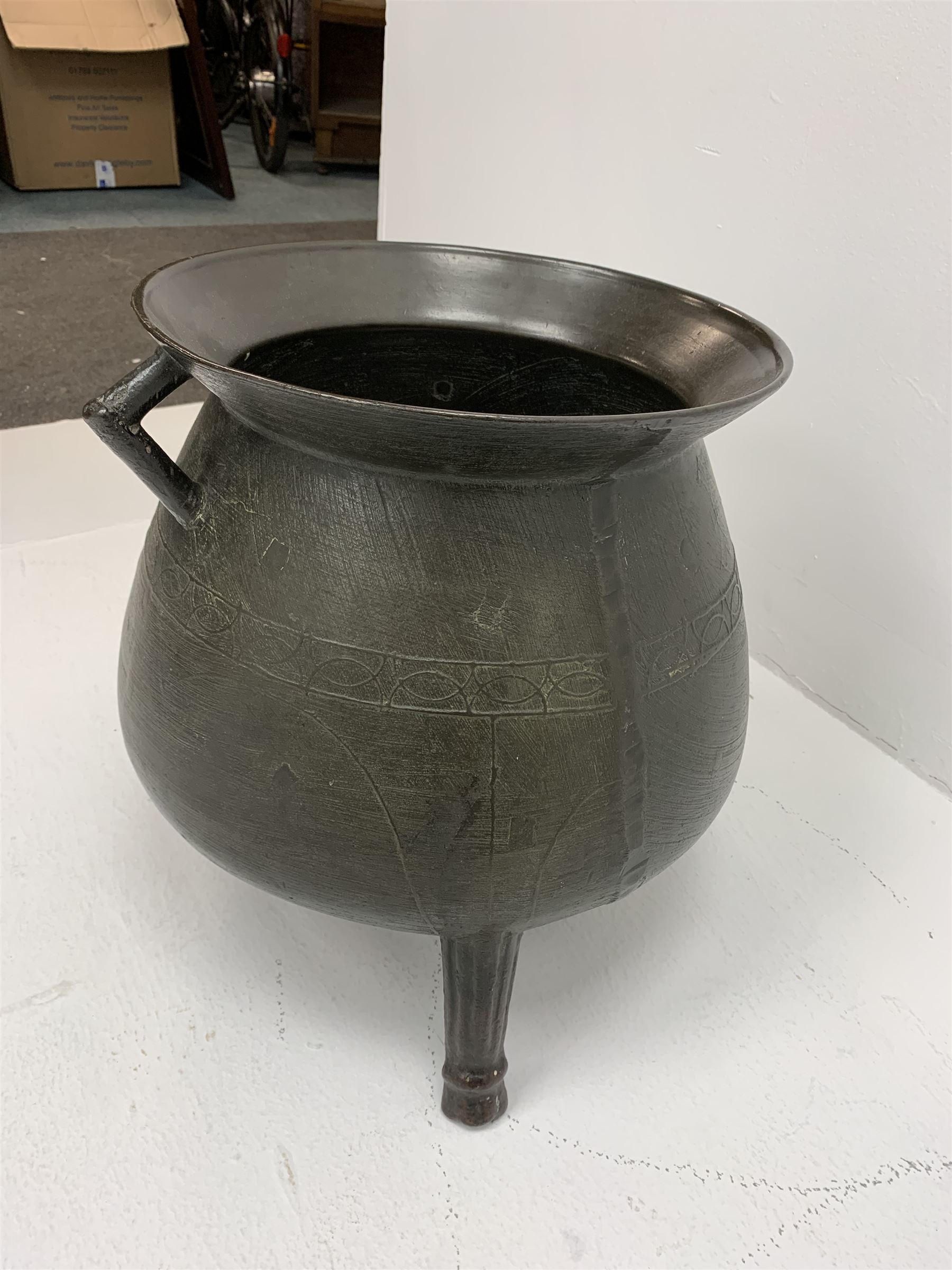 Late 17th/early 18th century bronze cauldron, of bellied form with flared rim and twin angular handles, upon three ribbed outswept feet, detailed with a decorative band beneath four arc founder's mark for John Sturton (I or II) of South Petherton, Somerset and a capital 'I', H40cm, rim D36cm