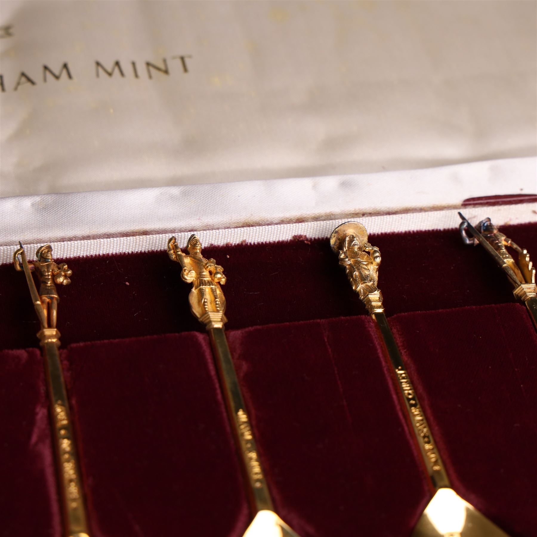 Set of twelve 'The Tichborne Collection' silver gilt spoons, each with fig shaped bowls, the finials depicting different historical figures including Queen Elizabeth, Hector of Troy and Saint Peter, hallmarked Birmingham Mint 1978, in fitted case