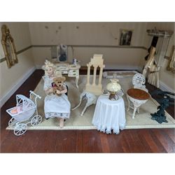 Two modern three storey dolls houses, each painted green with decorated interiors, both upon a single white wooden base, together with a large collection of dolls house furniture, accessories and figures 