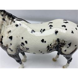 Two Beswick figures of horses, comprising Dun highland pony, model no 1644, together with Appaloosa stallion, model no 1772, both with printed mark beneath, largest H20cm