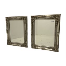 Pair of small wall mirrors in classical silver swept frame, bevelled plate