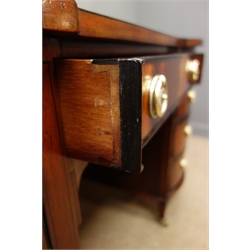  Edwardian twin pedestal mahogany and ebony inlaid desk, top inset with tooled blue leather writing surface, eight graduating curved drawers, one central drawer, square tapering supports on castors, W122cm, H76cm, D64cm  