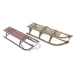 Two vintage davos wooden sledges with metal runners, L114cm and L106.5cm