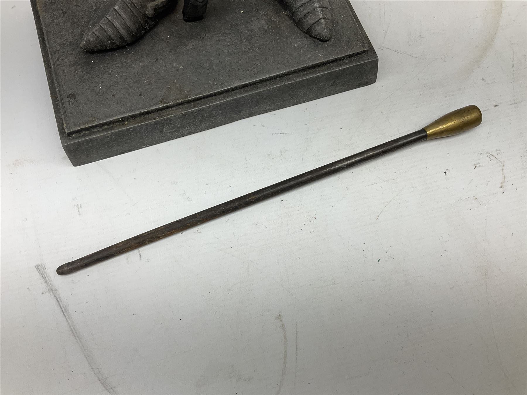 Cast iron fire companion set modelled as a knight in armour with fleur-de-lis shield and sword concealing fire poker, with brass tongs to reverse, raised upon stepped rectangular base, H55cm