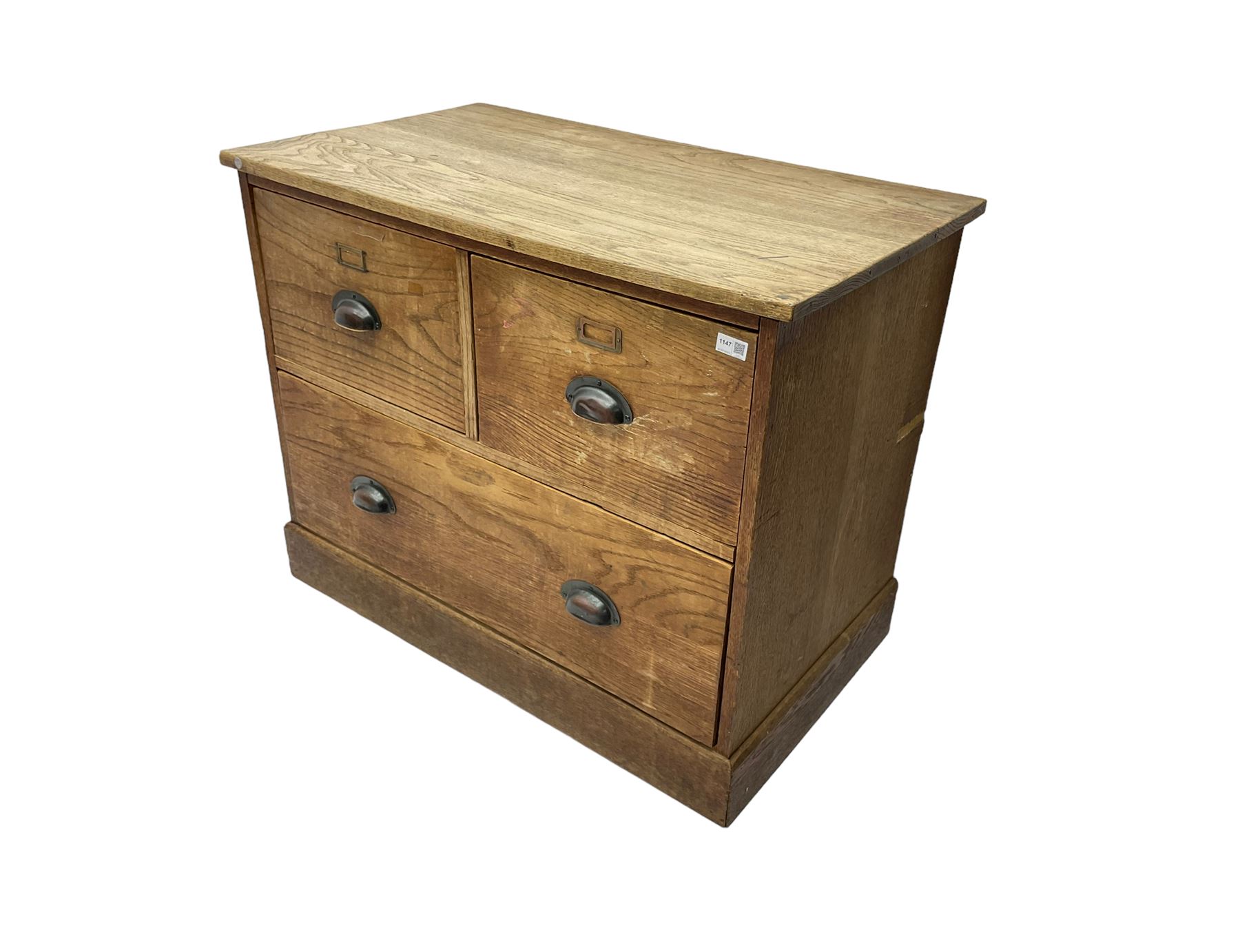 Early to mid-20th century oak chest, fitted with two short drawers over one long drawer, raised on plinth base