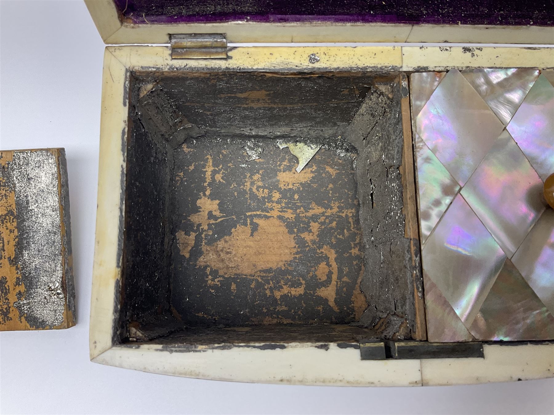 Victorian mother of pearl tea caddy, of rectangular bow-fronted form, the body with floral, bird and geometric engraved mother of pearl panels, white metal shield plaque to the cover inscribed with the initials G.J.A and similar escutcheon, the two division interior with ivory edging and two panelled mother of pearl lids, on four vegetable ivory bun feet L20cm, together with a similar style mother of pearl card case (2) This item has been registered for sale under Section 10 of the APHA Ivory Act