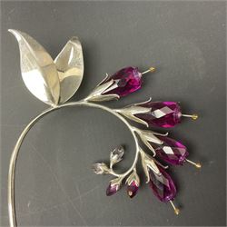 Eleven Swarovski Crystal flowers, to include violet, sunflower, delphinium, forget-me-not and lily-of-the-valley, each on stylised metal stems, tallest H23cm