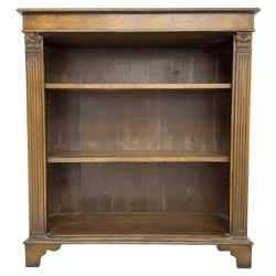 Georgian design walnut open bookcase, fluted uprights with acanthus carved capitals enclosing two adjustable shelves, on bracket feet