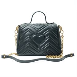 Gucci GG Marmont black matelassé leather top handle bag, made in Italy, with chevron quilted leather and heart motif to the reverse, antique gold-tone Double G front hardware, leather top handle and detachable chain shoulder strap with leather shoulder guard, front flap closure, suede-effect interior with zip pocket and leather logo tab stamped Gucci made in Italy, together with original Gucci dust bag and carrier, W27cm D11cm H20cm