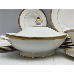 Royal Doulton Royal Gold pattern tea and dinner service for eight, comprising dinner plates, side plates, tea plates, soup bowls, sauce boat and saucer, dessert bowls, coffee cans and saucers, teacups and saucers and two lidded tureens