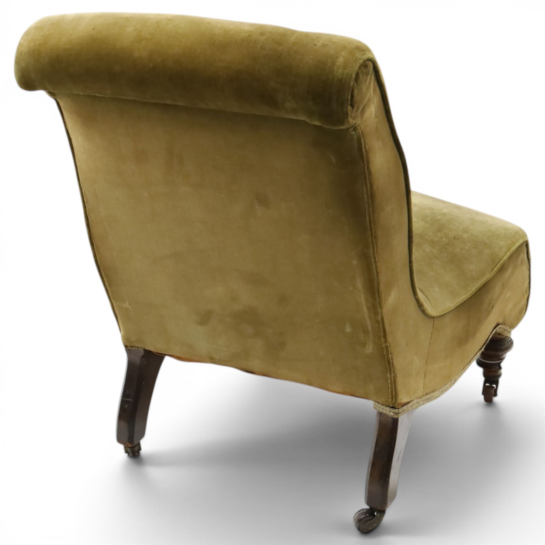 Victorian mahogany framed slipper chair, of reclined shape with rolled back over sprung seat, raised on turned feet with ceramic castors