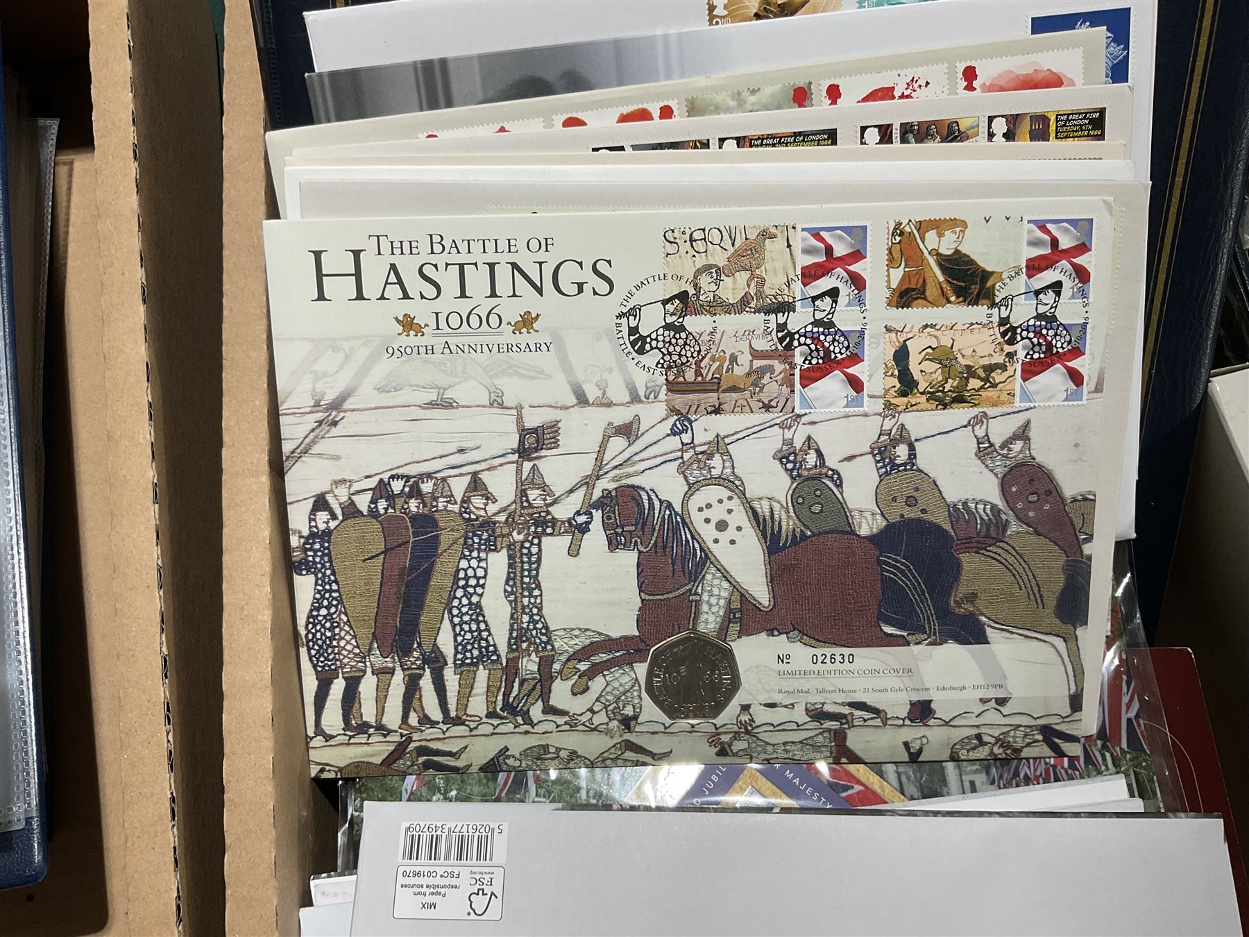 Approximately one hundred and fifteen Royal Mint coin covers, in two ring binder folders and loose, together with approximately 53 grams of Great British pre-1920 and approximately 68 grams of Great British pre-1947 silver threepence coins, and a small quantity of further pre-decimal coins