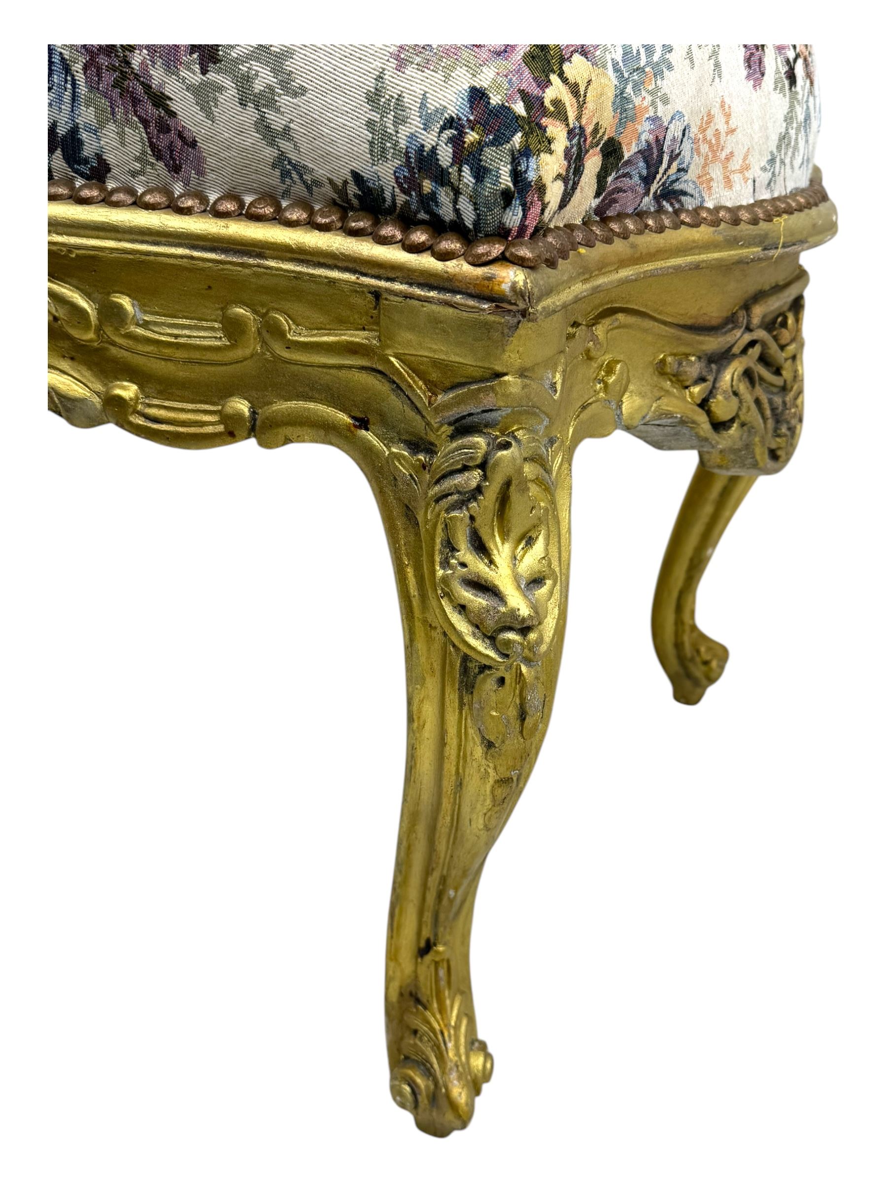 Pair of Louis XV-design giltwood stools, each upholstered in floral tapestry fabric, the carved frame adorned with scrolling foliage and shell motifs, raised on cabriole supports