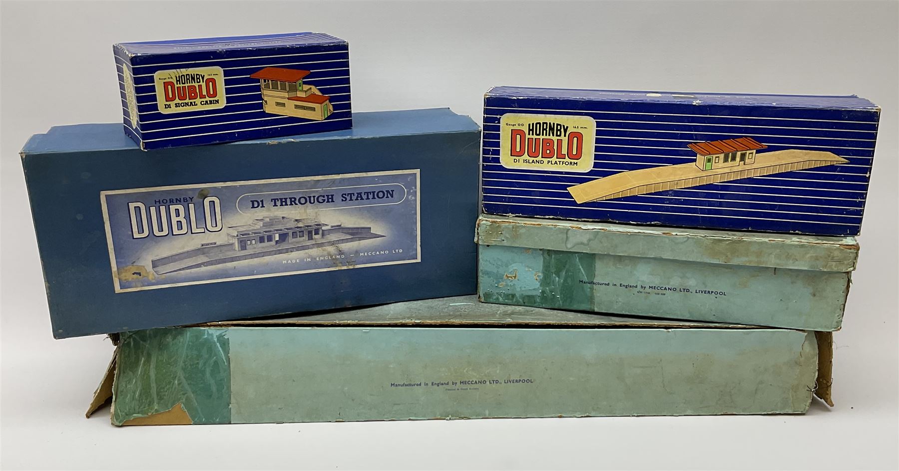 Hornby Dublo - wooden D1 Main Line Station and D1 Goods Depot, both in pale blue boxes; die-cast D1 Through Station in plain blue box; die-cast D1 Island Platform and D1 Signal Cabin, both in blue striped boxes (5)