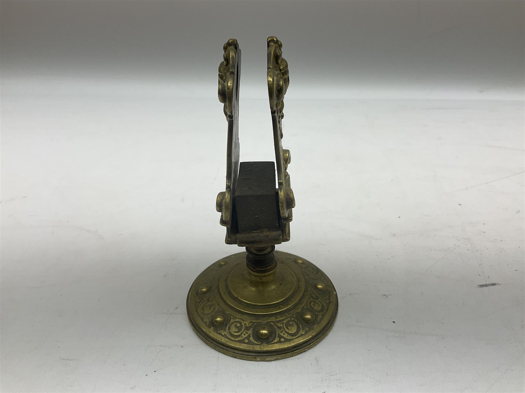 Collection of victorian and later brass desk accessories, to include a letter holder with cherub design, ink well of square form with hinged lid, brass table bell, brass casket with relief decoration, etc  