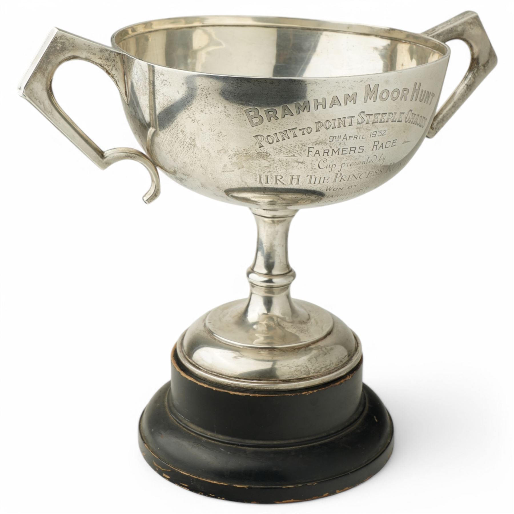  'Bramham Moor Hunt Point to Point Steeplechases' - A two handled silver cup presented by H.R.H. The Princess Royal on ebonised plinth D23cm x H23cm excluding plinth, Birmingham 1931 Maker William Hutton & Sons Ltd
