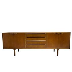 Tom Robertson for AH McIntosh & Co of Kirkaldy - mid-20th century teak sideboard, fitted with four central drawers, flanked by cupboard enclosing shelves and sliding tray, raised on cylindrical supports