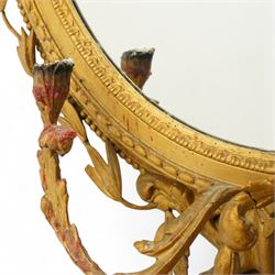 Late 19th century Louis XVI style giltwood and gesso girandole oval wall mirror, the oval frame surmounted with stylized urn finial and ribbon-tied garlands, laurel swags and rosettes, egg and dart decorated inner moulding and linked acorn outer moulding, flanked by intertwined foliate decorated candle branches 