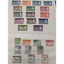 Mostly Commonwealth or Empire stamps including Queen Elizabeth II Northern Rhodesia, Nyasaland, Solomon Islands, Aden, Bermuda, Grenada 'Associated Statehood' overprints, King George VI Falkland Islands Dependencies with values to one shilling etc, mixture of mint and used, housed in a green stockbook