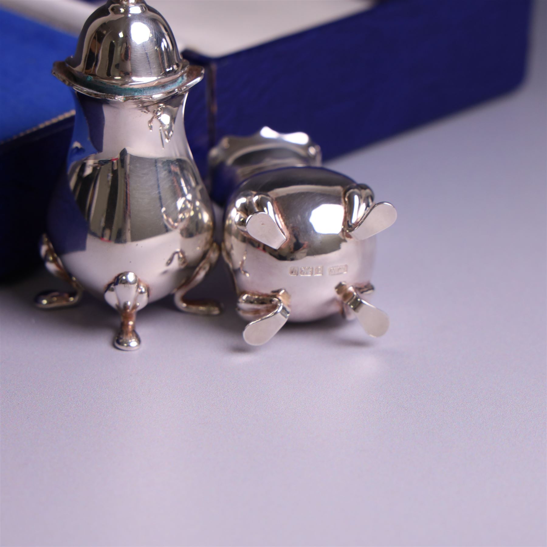 Pair of silver cruets, of baluster form and upon four pad feet, hallmarked Laurence R Watson & Co, Birmingham 1993, together with a set of six silver handled tea knives, hallmarked Barker Brothers Silver Ltd, Sheffield 1955, both in fitted cases
