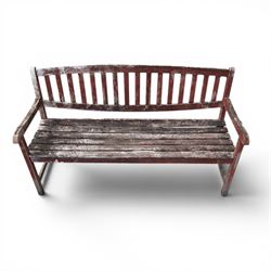 Teak garden bench, with slatted seat and spindle back, shaped armrests, finished in weathered red painted finish.