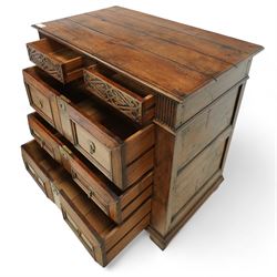 John Nethercott & Co - late 20th century hand-made oak 17th-century design chest of drawers, rectangular pegged and planked top above scrollwork carved frieze concealing two drawers, over three drawers, all with raised rectangular moulding and drop handles, raised on stile feet, the back with dated label for John Nethercott & Co