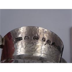 Modern Arts and Crafts style silver jug, of waisted form with fluted rim, with hammered finish throughout, hallmarked John Henry Pank, London 1977, with Hull town mark, H9.8cm