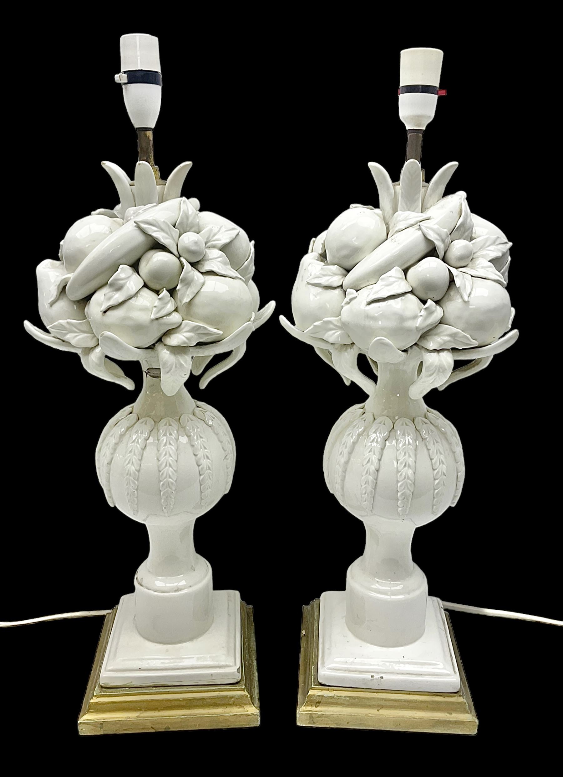 Pair of Casa Pupo white-glazed table lamps, modelled as a fruit upon a column of baluster form with foliate decoration, on a giltwood base, H62cm