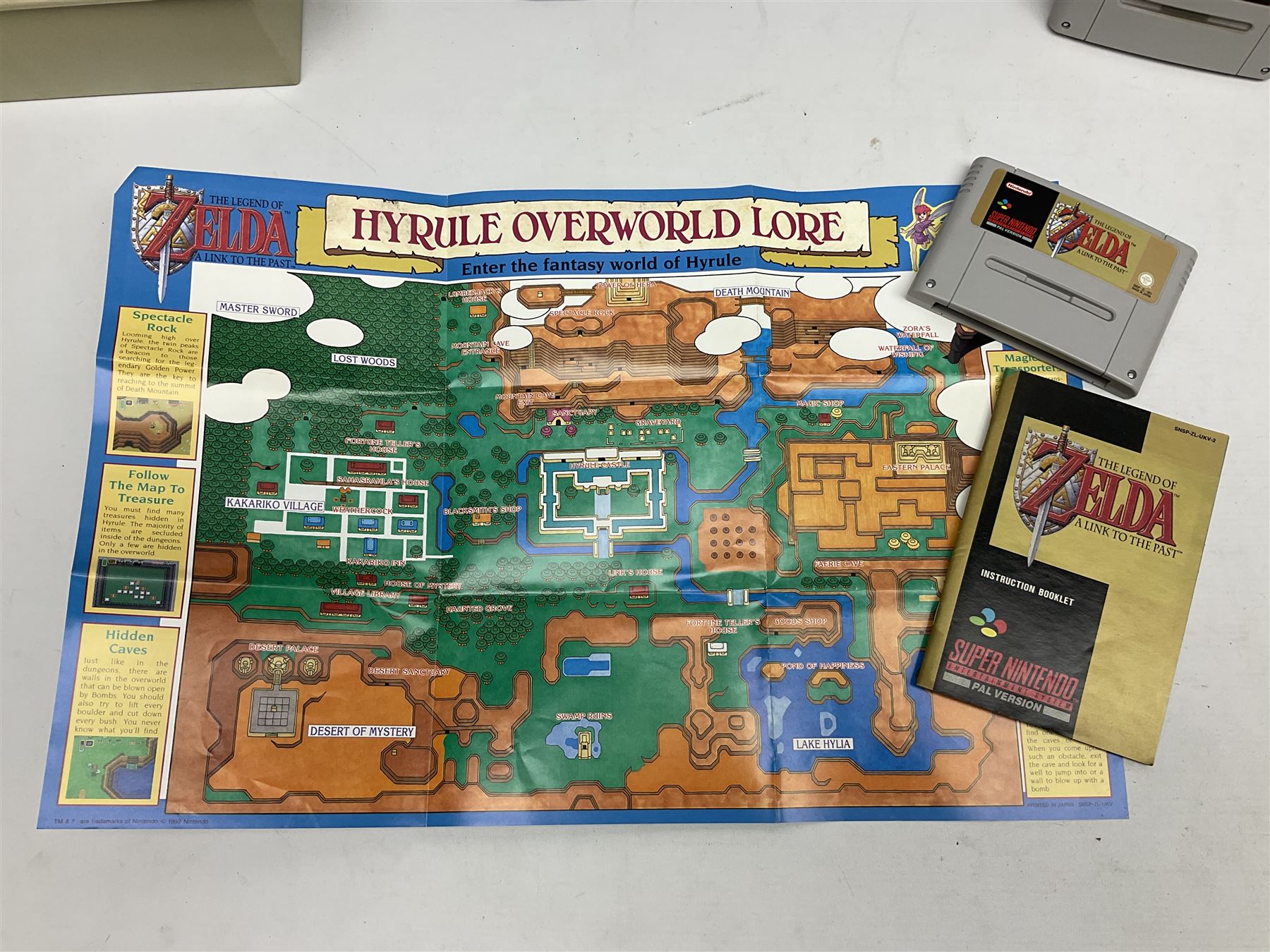 Two Super Nintendo Entertainment System (PAL) controllers, accessories and games. Super NES Game Commander with original box and instruction booklet, Super NES Nintendo Scope (1992) transmitter gun, receiver, Super NES Nintendo Scope 6 game with original instruction booklets. Further games to include ‘The Legend of Zelda a Link to the Past’, ‘Super Mario World’, ‘Super Mario Kart’, ‘The Lawnmower Man’, and ‘Exhaust Heat’, all with original instruction booklets. ‘PowerMonger’ and Disney’s ‘Aladdin’ game cartridges only 