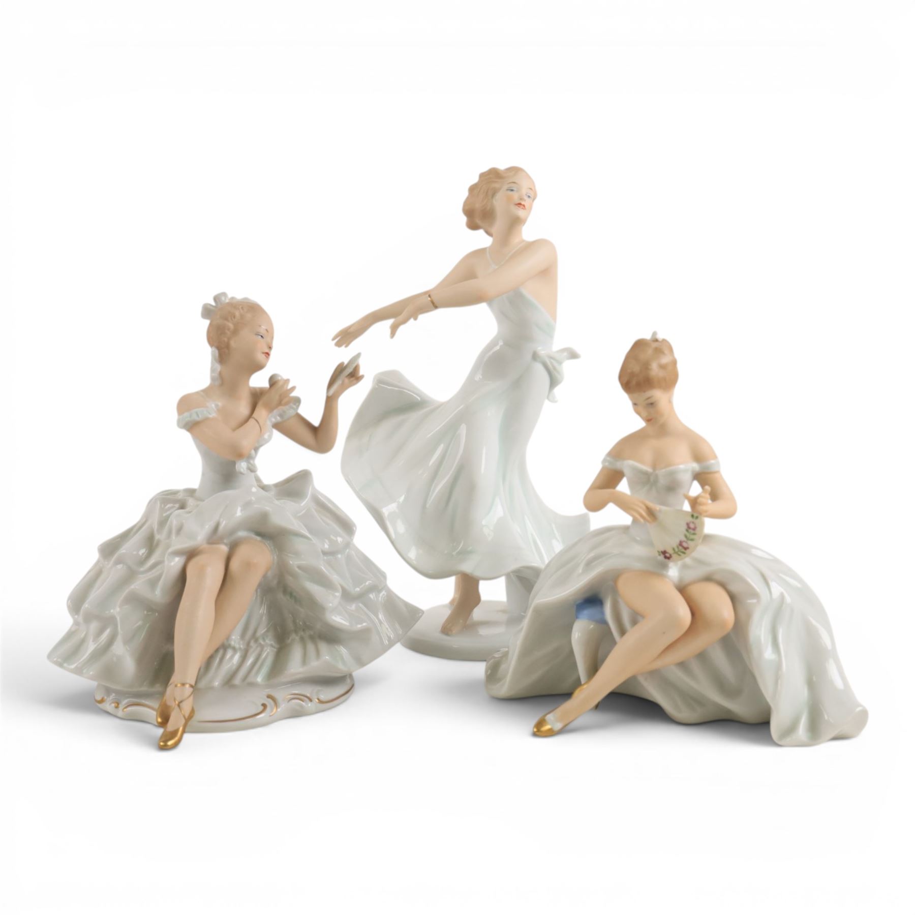 Three Wallendorf figures, comprising Girl seated with fan 1590/1, Girl with fan 1396/1 and Girl Dancing 1507, tallest H27cm