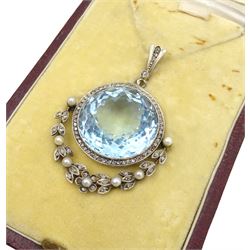 Early 20th century silver and platinum aquamarine, diamond and pearl pendant, the round cut aquamarine of approx 27.00 carat, with milgrain set diamond surround and hinged diamond and pearl set foliate drop, circa 1910-1920, in fitted box, retailed by Diss & Sons, Dewsbury
