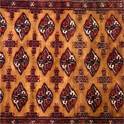 North East Persian Turkoman hand-knotted rug, camel brown field decorated with repeating rows of octagonal guls, interspersed with small geometric motifs enclosed within narrow guard borders in a palette of madder red, brown, and ivory, with cotton fringe ends  