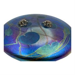 John Ditchfield for Glasform disc paperweight in iridescent purple with green lily trail and a pair of silver hallmarked frogs to top, D14cm