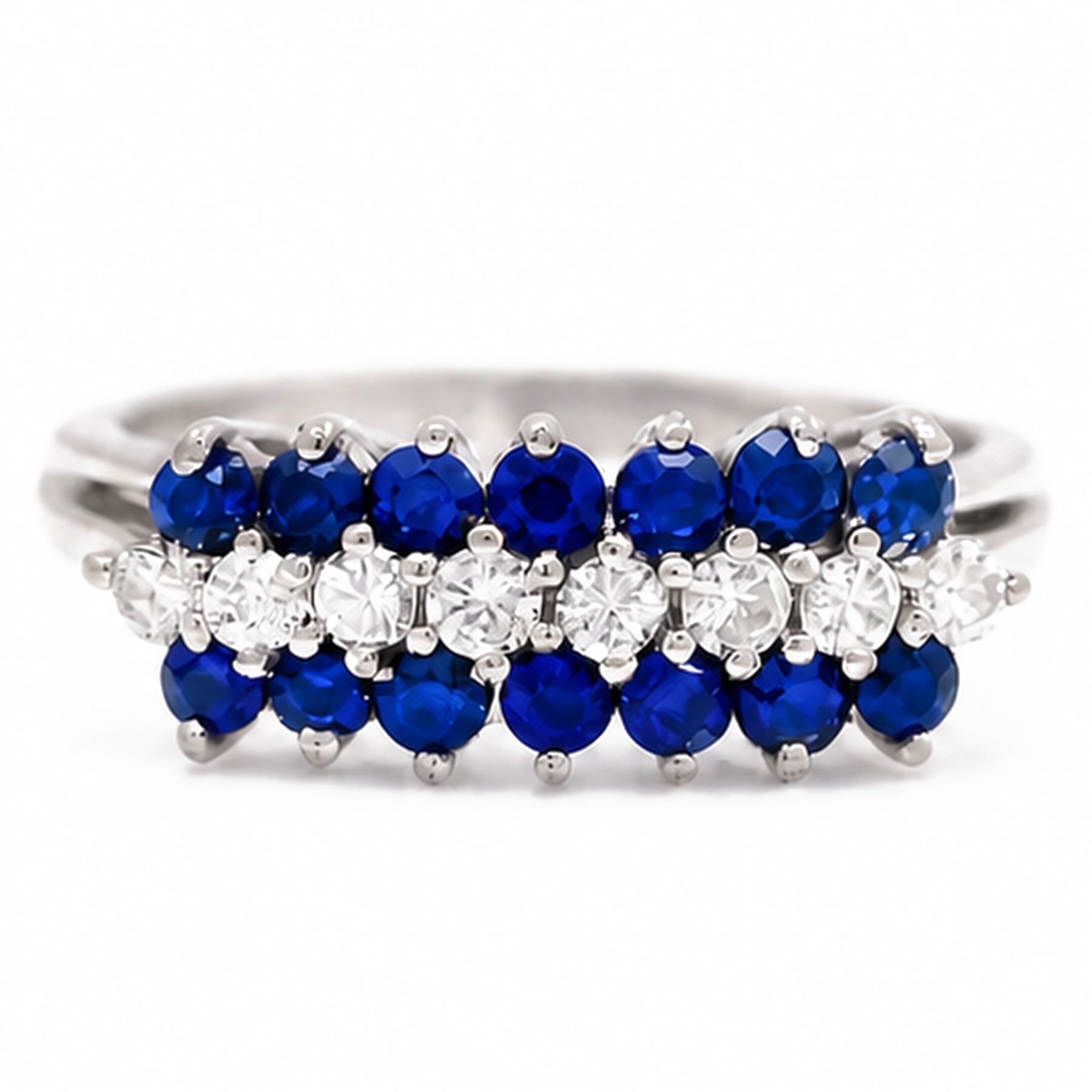 White gold diamond and sapphire three row ring, eight round brilliant cut diamonds, set between two rows of round cut sapphires, stamped 18ct, total diamond weight approx 0.30 carat