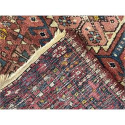 Belgian Sultan woollen ground rug, central navy field densely decorated with floral sprays and geometric patterns (192cm x 135cm); handwoven tribal terracotta ground rug (121cm x 71cm); Persian crimson ground runner, all over stylised floral and foliate motifs (266cm x 94cm)