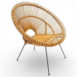 Janine Abraham and Dirk Jan Rol - Mid 20th century rattan sun lounger chair, circular openwork seat and back formed of radiating cane spindles with looped rim, raised on slender black metal tripod supports