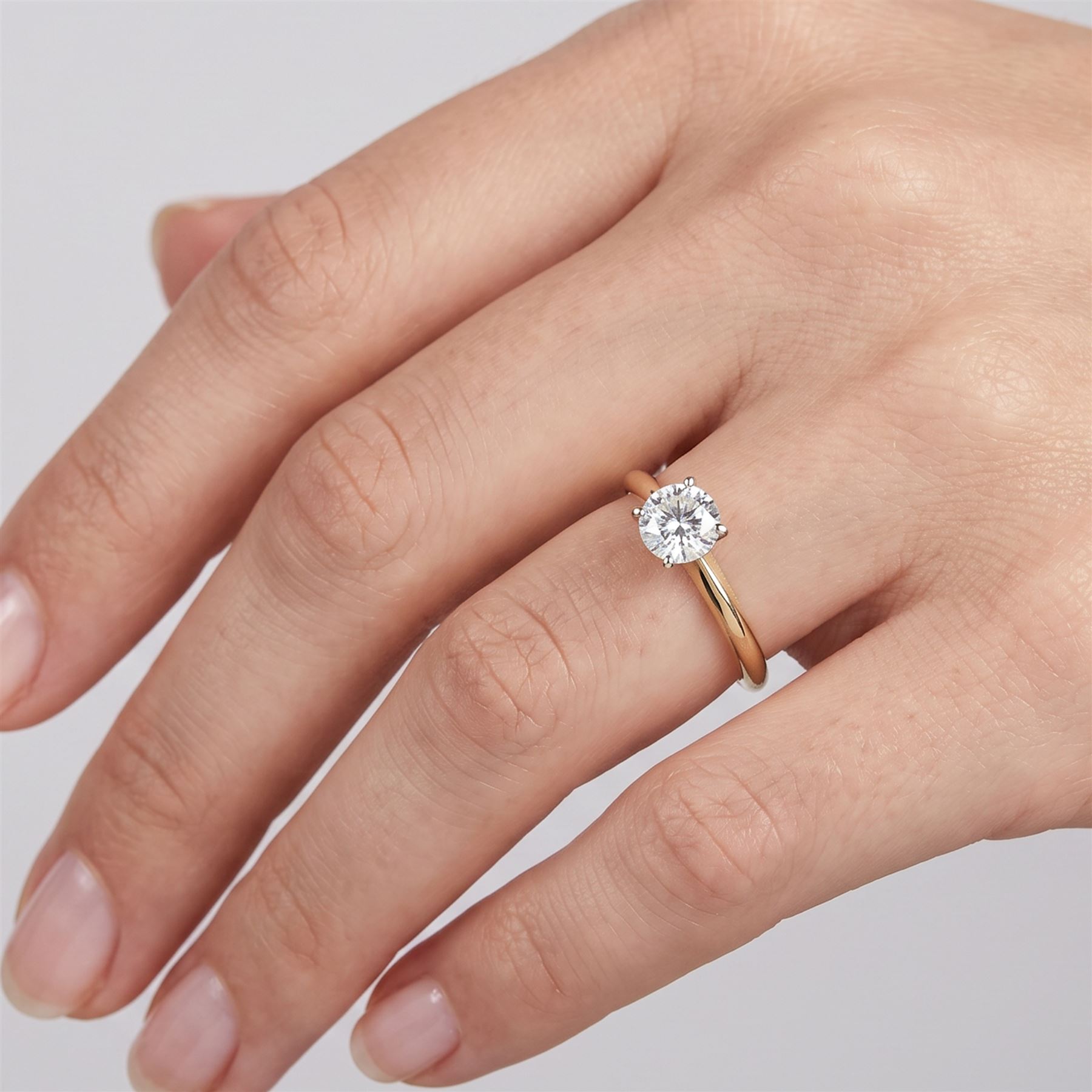 14ct gold diamond ring, four claw set with a single round brilliant cut diamond of 0.61 carat, stamped