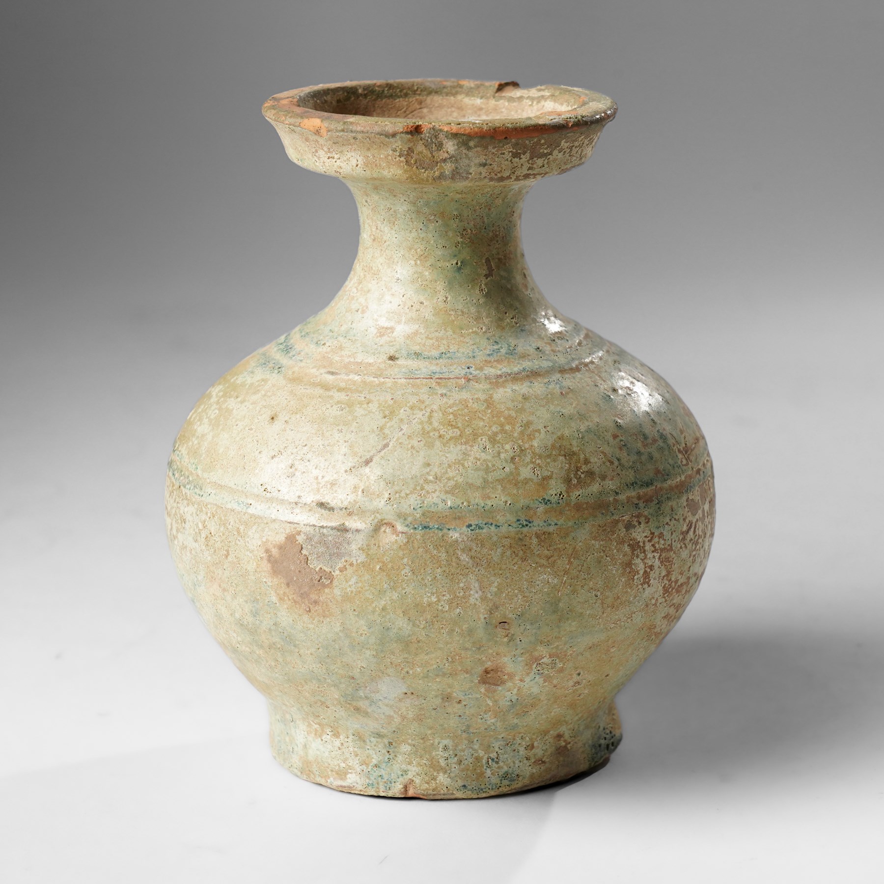 Green glazed 'Hu' jar, probably Han Dynasty, with flared rim H15.5cm 
