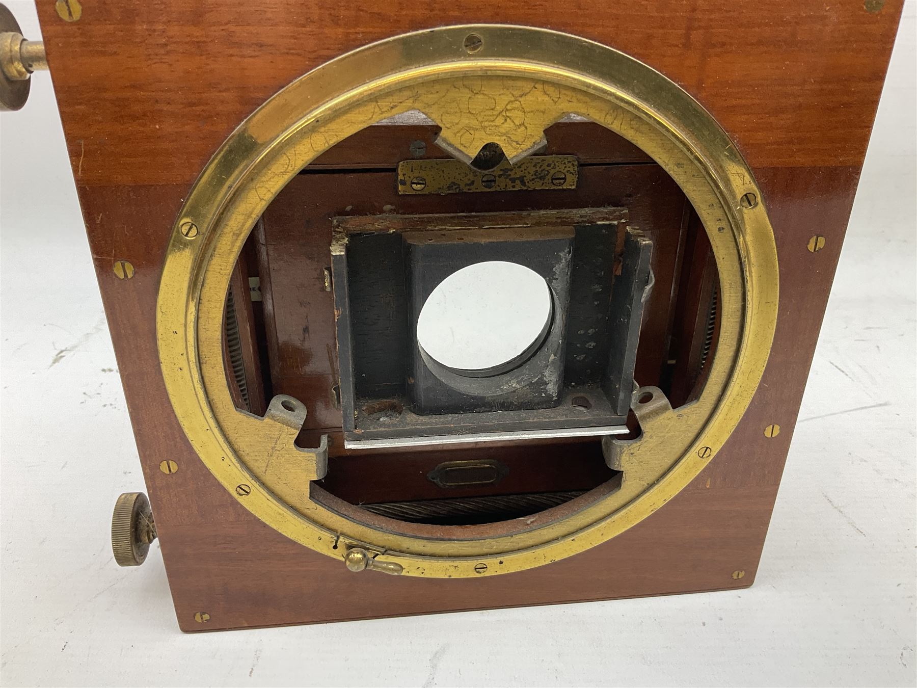 Ensign 'The Sanderson' folding plate camera in mahogany and lacquered brass, field model with canvas wrapped box, two mahogany photographic plates, 'Busch rapid Symmetrical F:8' lens,  and a wooden tripod 