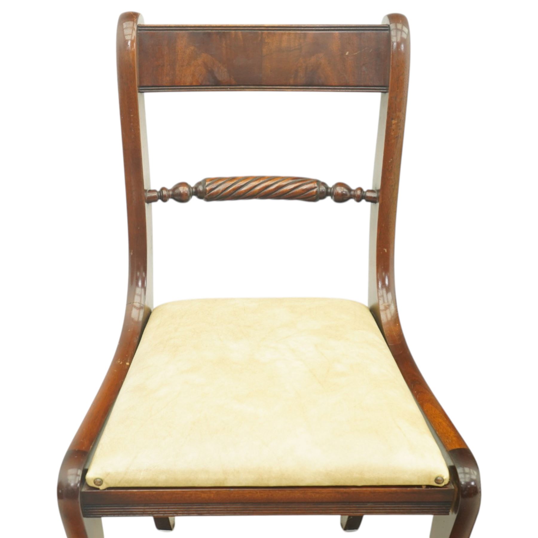Late 20th century Regency style mahogany dining chairs, set of four, bar backs with figured veneered top rails and turned spindle stretchers, drop-in seats upholstered in beige leather, on moulded sabre supports